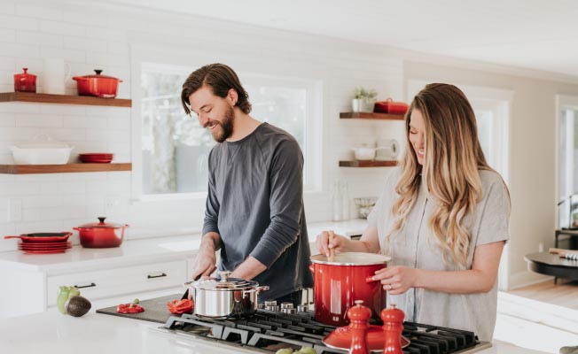Level Term Plan - Man and woman cooking together in kitchen | Photo by Becca Tapert on Unsplash